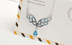 925 Sterling Silver Coated Angel Wings Pendant Necklace with Paved Stones and Teardrop CZ Crystal - Turquoise Blue