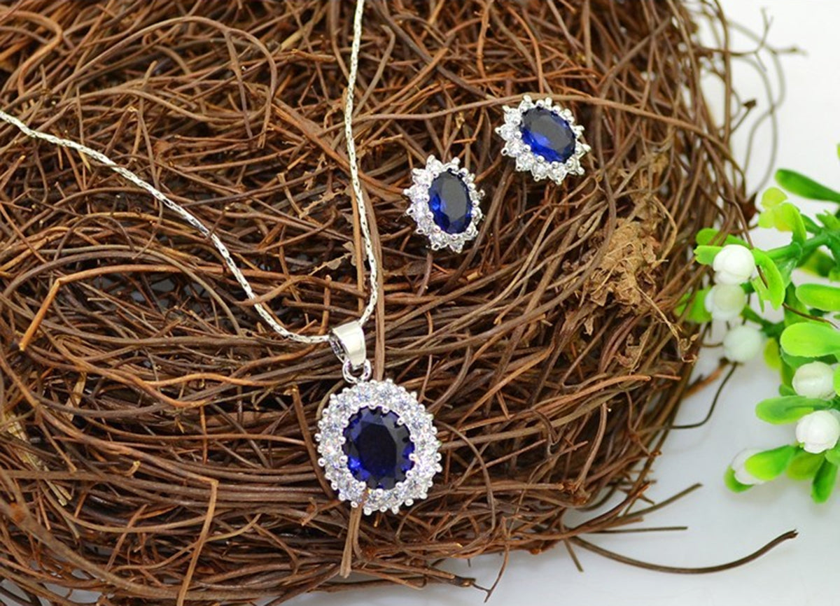925 Sterling Silver Coated Oval Crystal Flower Pendant Necklace Adorned with White Stones - Sapphire Blue